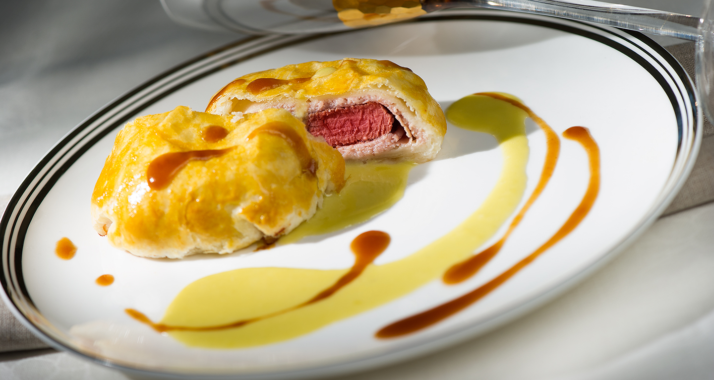 BEEF FILLET IN PUFF PASTRY CRUST WITH COOKED HAM ON FONTINA FONDUE